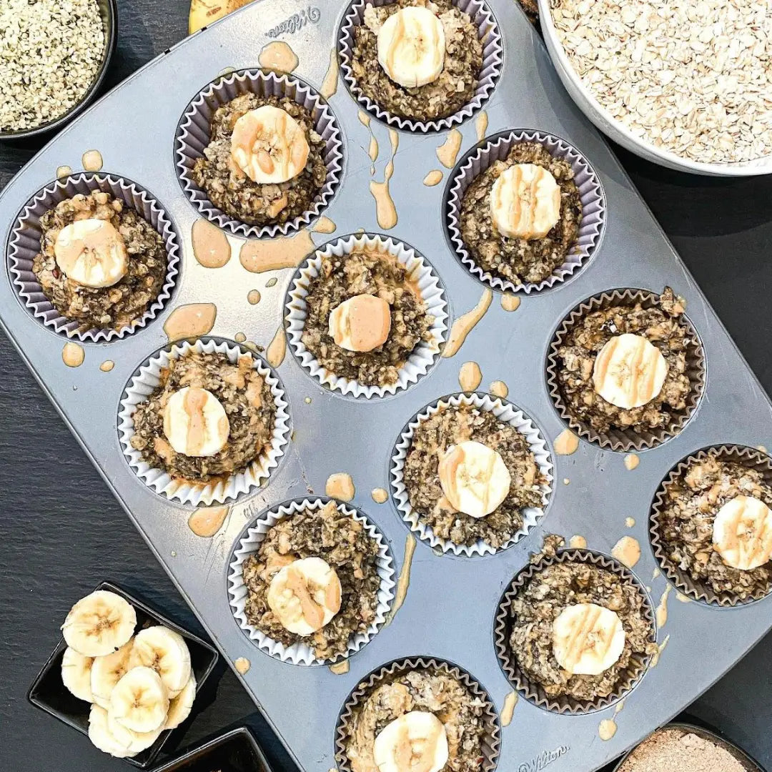 Banana Peanut Butter Doggy Oatmeal in a muffin tin with banana on top