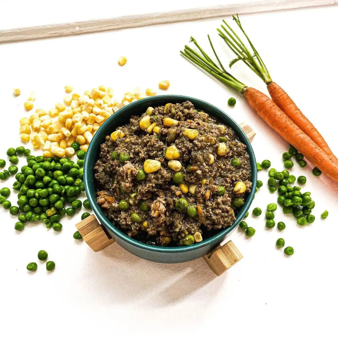 shepherd's pie with peas and corn and carrots around it