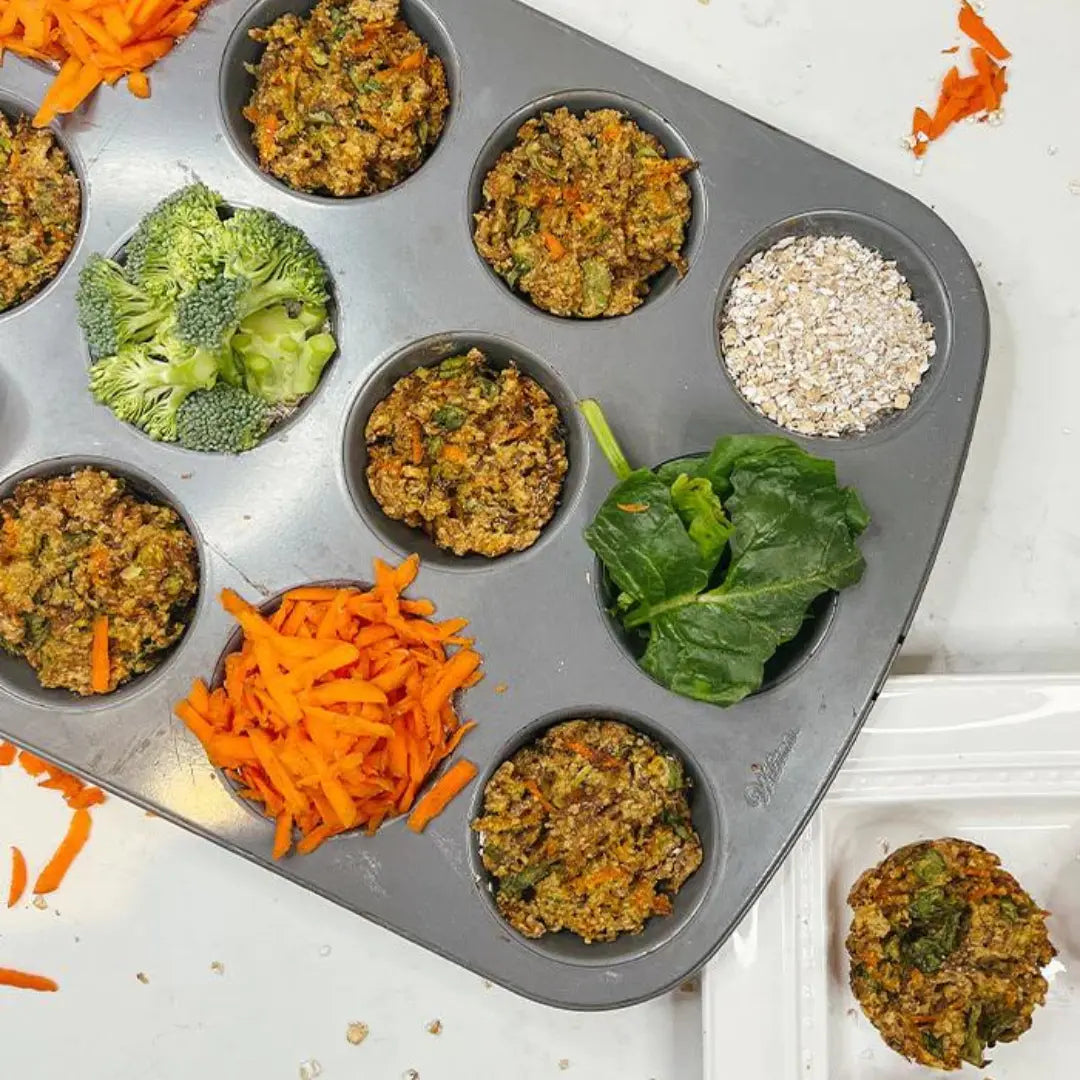 Muffin tray with broccoli, carrots, and broccoli chicken pucks